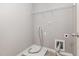 Functional laundry room with a wire shelf, and connections for a washer and dryer at 102 Bella Pl, Holly Springs, NC 27540