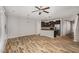 Open-concept living space with wood floors flowing into a modern kitchen with an island at 102 Bella Pl, Holly Springs, NC 27540