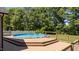 Backyard pool features a wooden deck and ladder at 112 Roping Horn Way, Willow Springs, NC 27592
