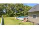 An inviting above ground backyard pool with a wooden deck and ladder steps at 112 Roping Horn Way, Willow Springs, NC 27592