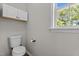 Half-bath features a white toilet, white cabinet, and bright window at 112 Roping Horn Way, Willow Springs, NC 27592