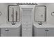 Bathroom featuring double sinks, storage, and mirrors for a modern design at 112 Roping Horn Way, Willow Springs, NC 27592
