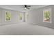 Large bedroom with three big windows and neutral carpeting at 112 Roping Horn Way, Willow Springs, NC 27592