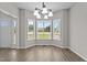 Airy dining room featuring lovely floors, a bay window, and a modern light fixture at 112 Roping Horn Way, Willow Springs, NC 27592