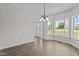 Bright dining area with beautiful wood floors, modern lighting and large windows at 112 Roping Horn Way, Willow Springs, NC 27592