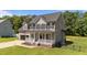 Attractive two-story home boasting a cozy front porch and attached two-car garage at 112 Roping Horn Way, Willow Springs, NC 27592