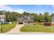 Inviting home featuring a well-manicured lawn, blacktop driveway, and a charming front porch at 112 Roping Horn Way, Willow Springs, NC 27592