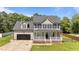 Charming two-story home featuring a welcoming front porch and attached garage at 112 Roping Horn Way, Willow Springs, NC 27592