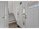 Foyer featuring staircase with carpet, wood flooring, and front door with glass at 112 Roping Horn Way, Willow Springs, NC 27592