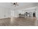 Open-concept living room flowing into a kitchen with stainless appliances and stone-accented breakfast bar at 112 Roping Horn Way, Willow Springs, NC 27592
