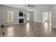 Spacious living room with a fireplace, large windows, and beautiful flooring at 112 Roping Horn Way, Willow Springs, NC 27592