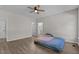 Spacious main bedroom featuring hardwood floors, ceiling fan, and two entryways at 112 Roping Horn Way, Willow Springs, NC 27592