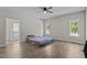 Main bedroom with hardwood floors, ceiling fan, three large windows and en-suite bathroom at 112 Roping Horn Way, Willow Springs, NC 27592
