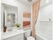 A stylish bathroom with a modern vanity, tub and shower combo at 1169 Abbott St, Mebane, NC 27302