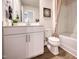 A pristine bathroom features a white vanity, toilet, and shower with a neutral shower curtain for a clean aesthetic at 1169 Abbott St, Mebane, NC 27302