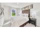 A serene bedroom featuring a cozy bed, stylish nightstands, elegant lamps, and inviting decor at 1169 Abbott St, Mebane, NC 27302