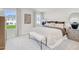 Elegant bedroom featuring a plush bed with tufted headboard, bench, and soft neutral color palette at 1169 Abbott St, Mebane, NC 27302