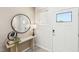 Bright entryway with stylish console table, round mirror, and a door with glass panel at 1169 Abbott St, Mebane, NC 27302
