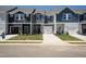 Row of new two-story townhomes with driveways, lawns, and varied siding and door colors at 1169 Abbott St, Mebane, NC 27302