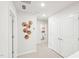Bright hallway with multiple doors and geometric wall art, leading to various rooms in the home at 1169 Abbott St, Mebane, NC 27302