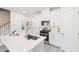 Modern kitchen with white cabinets, stainless steel appliances, and quartz countertops for cooking and entertaining at 1169 Abbott St, Mebane, NC 27302