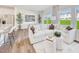 A spacious open-concept living room with modern furniture seamlessly connects to a dining area, bathed in natural light at 1169 Abbott St, Mebane, NC 27302