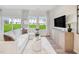 An inviting living room features a comfortable white sofa, stylish decor, and large windows with natural light at 1169 Abbott St, Mebane, NC 27302
