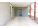 View of attached carport, featuring brick columns, a concrete floor, and a side door at 1212 St. Marys Rd, Hillsborough, NC 27278