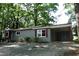 Charming brick home featuring a carport, fresh landscaping, and a welcoming entrance at 1212 St. Marys Rd, Hillsborough, NC 27278