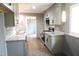 Updated kitchen featuring granite countertops, stainless steel appliances, light gray cabinetry, and modern tile backsplash at 1212 St. Marys Rd, Hillsborough, NC 27278