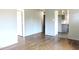 Open-concept living room with hardwood floors and direct access to the kitchen and other living spaces at 1212 St. Marys Rd, Hillsborough, NC 27278