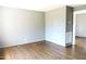 Open living room with hardwood floors and neutral walls, offering a bright and inviting space at 1212 St. Marys Rd, Hillsborough, NC 27278