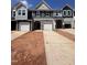 New construction townhomes feature stone accents, covered entrances, and individual garages at 1243 Hammond Dr, Mebane, NC 27302