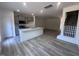 Open-concept kitchen with island, stainless appliances, and wood-look flooring in living area at 1243 Hammond Dr, Mebane, NC 27302