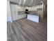 Modern kitchen with granite countertops, stainless steel appliances, and light grey wood floors at 1255 Hammond Dr, Mebane, NC 27302