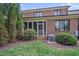 Well-manicured backyard featuring a screened porch, lush lawn, and tasteful landscaping at 129 Cofield Cir, Durham, NC 27707