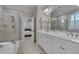 Bright bathroom with a double sink vanity, walk-in shower, and soaking tub at 129 Cofield Cir, Durham, NC 27707
