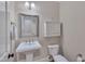 Half bathroom with pedestal sink, toilet, and mirrored wall cabinet at 129 Cofield Cir, Durham, NC 27707