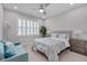 Bedroom with a ceiling fan, queen bed, and bedside tables at 129 Cofield Cir, Durham, NC 27707