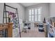 Craft room with large window, sewing machine, storage shelves, and crafting supplies at 129 Cofield Cir, Durham, NC 27707