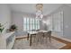 Bright dining room features modern light fixture, white marble-top table, and shuttered windows at 129 Cofield Cir, Durham, NC 27707