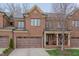 Charming brick townhome with a two-car garage, a covered entryway, and manicured landscaping at 129 Cofield Cir, Durham, NC 27707