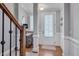 Bright foyer features hardwood floors, and white walls with classic trim details leading to a staircase at 129 Cofield Cir, Durham, NC 27707