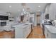 Open concept kitchen with white cabinets, stainless steel appliances, kitchen island, and hardwood floors at 129 Cofield Cir, Durham, NC 27707