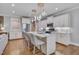 Bright kitchen features pendant lights, white cabinets, stainless steel appliances, and eat in counter at 129 Cofield Cir, Durham, NC 27707