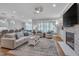 Inviting living room with fireplace, plantation shutters, hardwood flooring, and contemporary lighting at 129 Cofield Cir, Durham, NC 27707