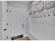 Mudroom with built-in bench seating, coat hooks, cubbies, and storage baskets at 129 Cofield Cir, Durham, NC 27707