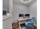 Home office with built in desk, dual monitors, grey walls, and ample natural light at 129 Cofield Cir, Durham, NC 27707