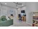 Office featuring a ceiling fan, sofa, desk with dual monitors, and bookshelves at 129 Cofield Cir, Durham, NC 27707