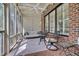 Beautiful sunroom featuring brick walls, a ceiling fan, and plenty of natural light at 129 Cofield Cir, Durham, NC 27707